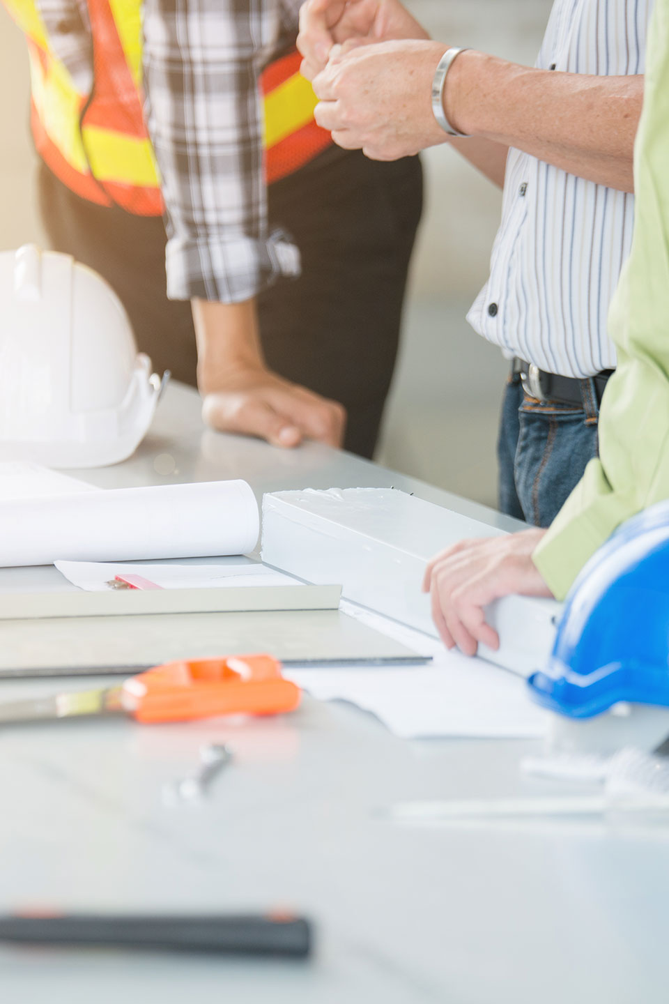 A group of people standing around some construction materials.