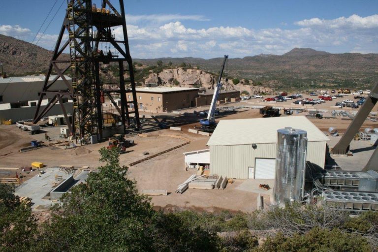 A view of an industrial area with buildings and construction equipment.