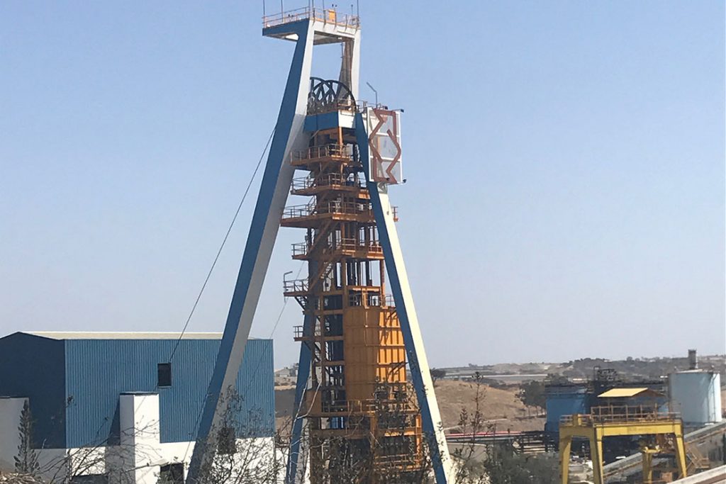 A large metal structure with a crane in the middle of it.