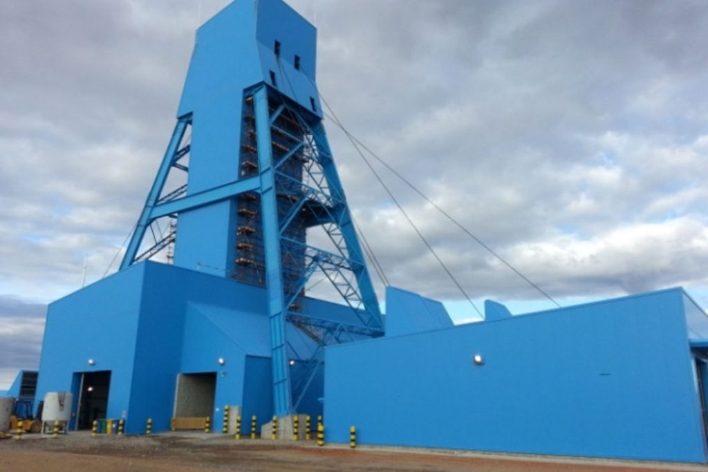 A blue building with a large tower on top of it.