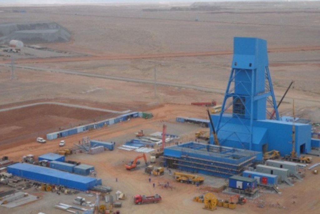 A large blue structure in the middle of an open field.